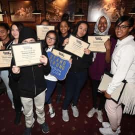 Students showing off their stand strong certificates.