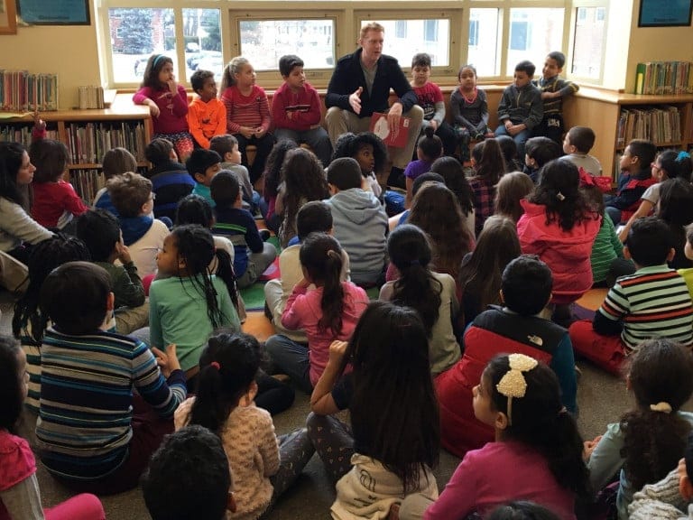 Brian Scalabrine talking to a large group of children in a library