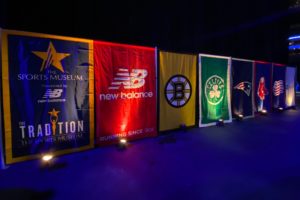 Backdrops of the event, sponsor, and Boston teams are lit up.