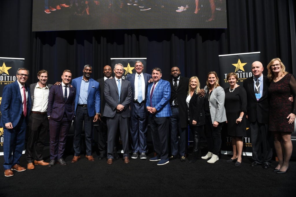 2021 Tradition Honorees with their presenters in a row on stage at the event