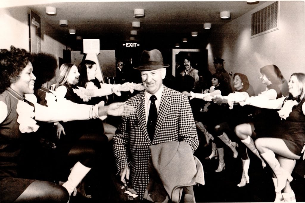 Billy Sullivan walking through cheerleaders